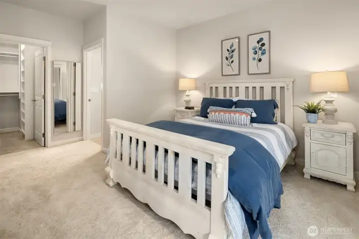 The primary closet is a large walk-in with built closet systems.