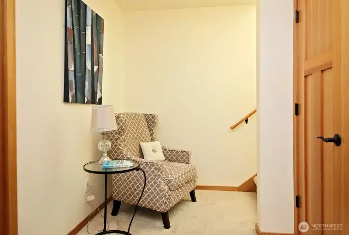 Landing at bottom of stairs is set up as a reading nook...  Brand new high capacity water heater, energy efficient. Installed late 2025, located in under stair closet for easy access!