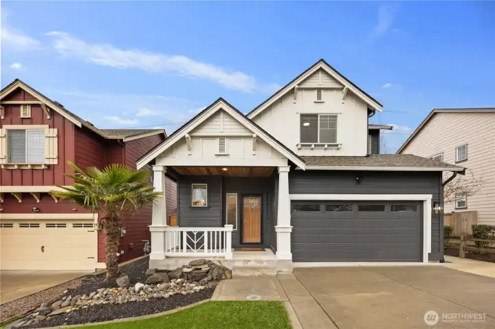 Charming craftsman-style home in Auburn with welcoming covered front porch, two-car garage, and clean modern exterior contrast. Thoughtfully designed front yard landscaping and inviting entry create strong curb appeal in this Ridge at Bowman Creek neighborhood home.