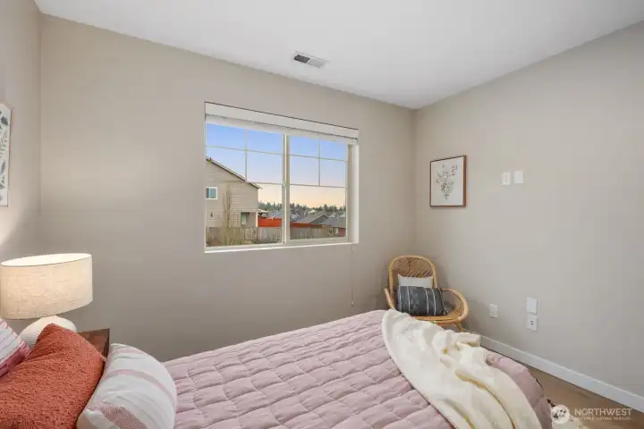 From this angle, the bedroom highlights its clean layout and warm, neutral tones that make the space feel bright and inviting. Natural light and simple styling create a peaceful setting for rest and relaxation.