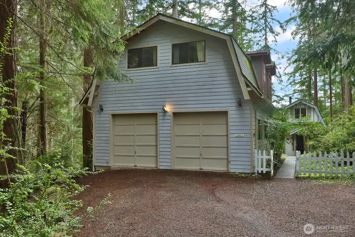 Main home with cabin. Besides of oversize garage, there is plenty of room for parking in the driveway.