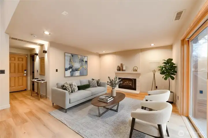 Spacious downstairs family room with gas fireplace, perfect for entertaining, with a slider exiting to the outdoor patio (virtually staged).