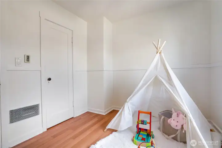 This room offers flexibility as a guest room, home office, or creative space, with a generously sized closet and built-in shelving.