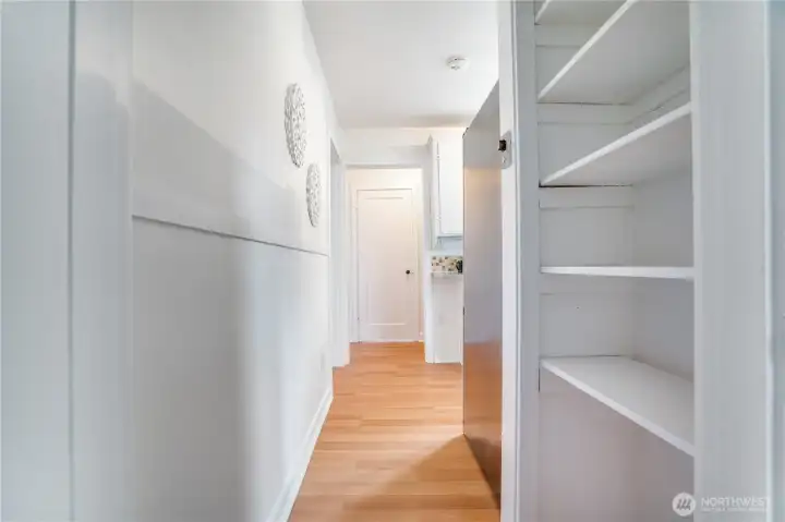 The fresh paint helps every part of the home shine—even the hallway, where additional built-ins offer extra storage or display space.