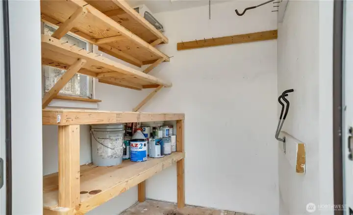 An exterior-access storage room with built-in shelving provides space for larger items like bikes, tools, or a lawnmower.