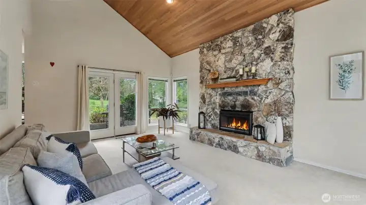 Walls of natural light surround this living room with French doors leading to the back patio.