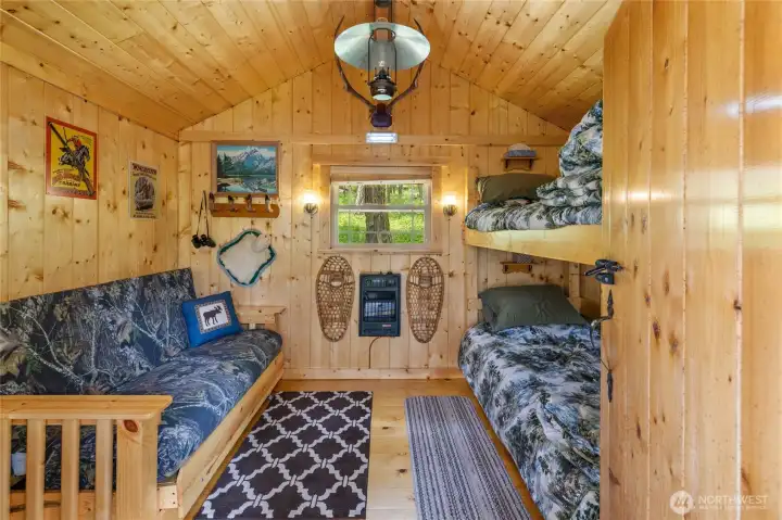 Bunkhouse with sleeping for 4. Fully self sufficient with solar lighting & propane heat.
