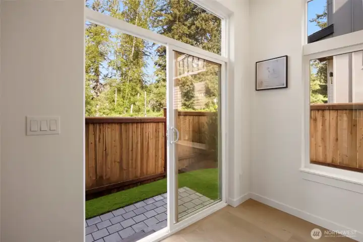 Slider access to the outdoor patio and fully fenced yard, perfect for pets.