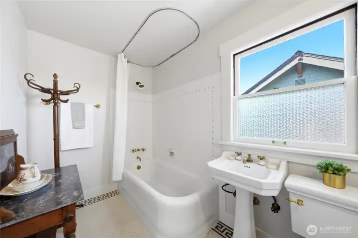 Beautifully restored, traditional craftsman style bathroom with refurbished brass fixtures