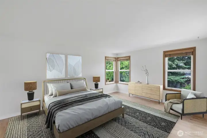 Primary bedroom with oak floors. virtually staged