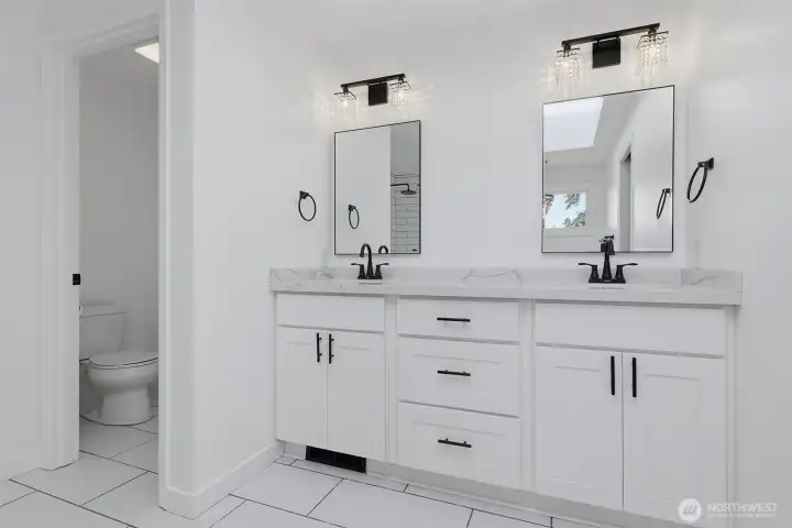 View of dual sink vanity in primary bath.