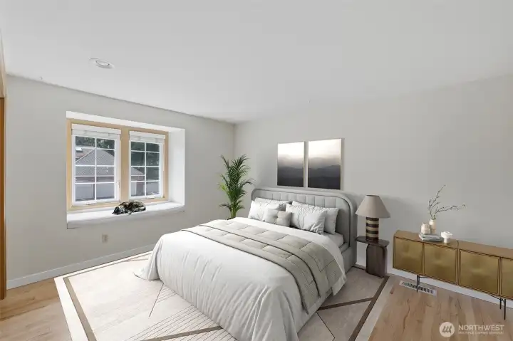 Upstairs bedroom with oak floors and built in seating next to windows. virtually staged