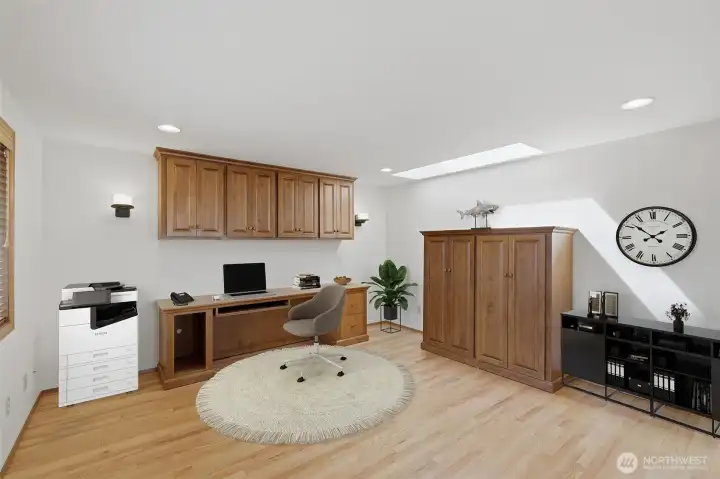 Upstairs Office/Loft has cutom made cabinetry and desk which are included in sale. virtually staged