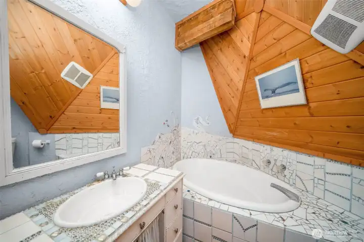 Spacious bathroom with large tub. Check out the custom tile design work! Spacious bathroom with large tub. Check out the custom tile design work!