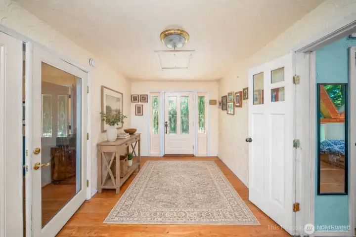 Second entry area leading to the primary bedroom to the right and the main living area. Second entry area leading to the primary bedroom to the right and the main living area.
