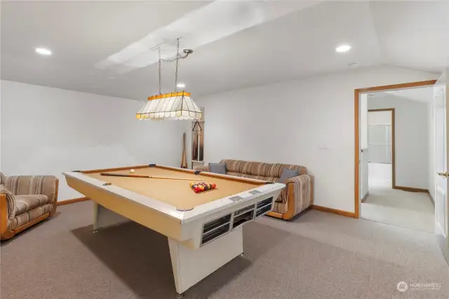 Large Game room, approximately 17’ x 15’, Pool Table with Light, can Lights and carpet.