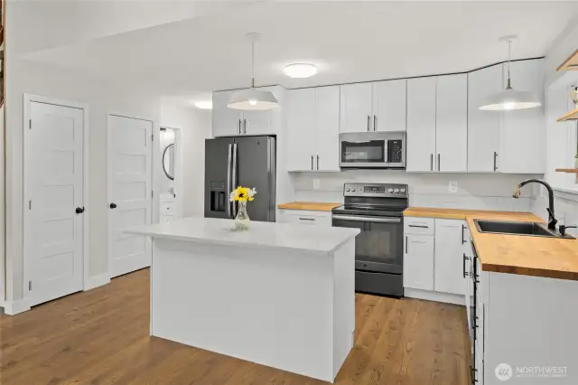 With a quartz island and wood counters, the kitchen well laid out.