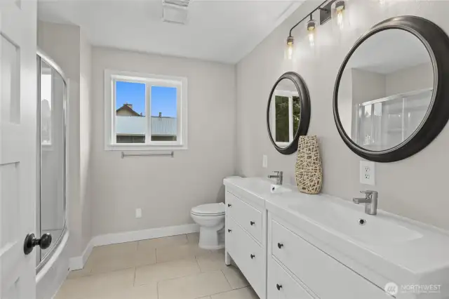Double sinks and a tub/shower combo in the oversized bathroom