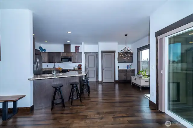 The kitchen bar provides additional seating while showcasing a well-designed layout with a convenient pantry and ample storage.