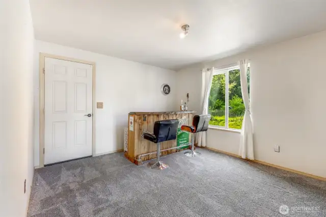Great downstairs bonus room with access to attached garage. (Sorry, bar does not stay.)