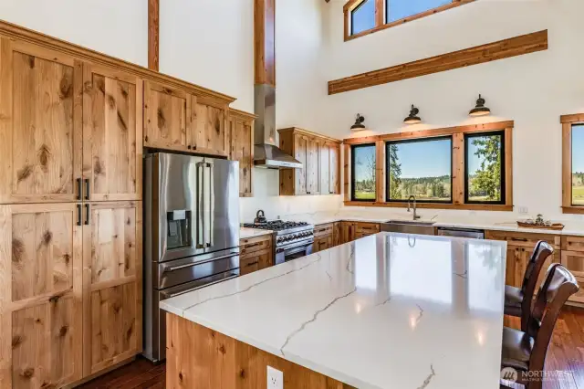 Extra large Quartz island  with eating bar and  storage on both sides