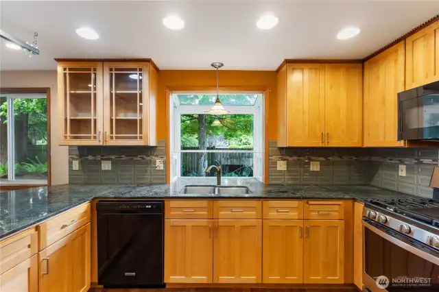 Nice mix of glass cabinets for displaying your best. Beautiful dentil crown moulding rounds out this custom look.
