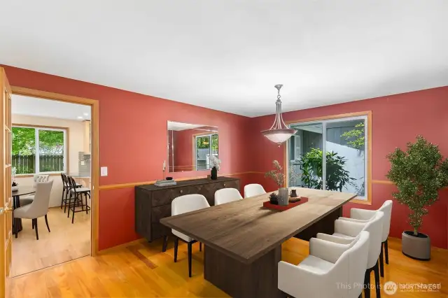 At the front of the house is a large dining room. Virtually staged here to show furniture placement options
