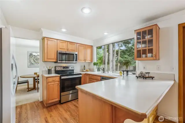 Kitchen with newer refrigerator, farmhouse sink, pull out shelves & lots of storage. All appliances included!