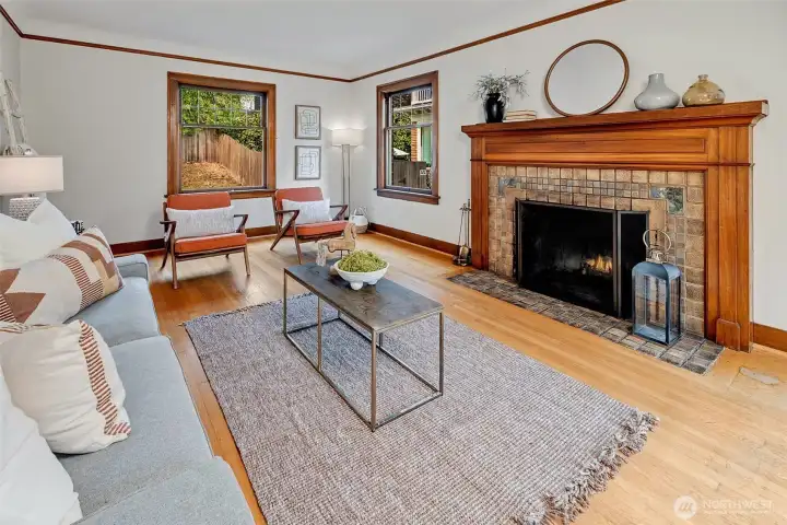 Sun drenched living room with gorgeous wood burning fireplace flanking the space