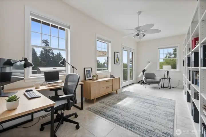 This huge virtually staged office has tons of windows for natural light