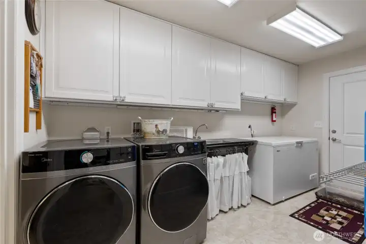Laundry and mudroom with backdoor right off the kitchen