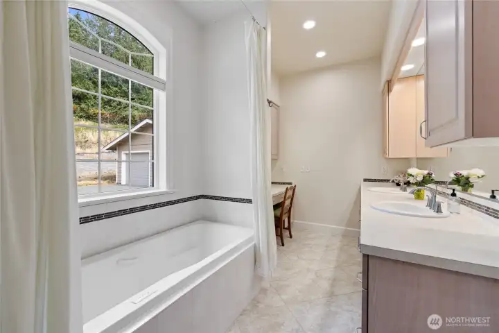 The bathroom has a huge cabinet with two sinks and a nice vanity to help you get ready for your day