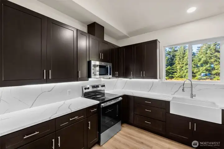 Locally made cabinetry, with full-height quartz backsplash!