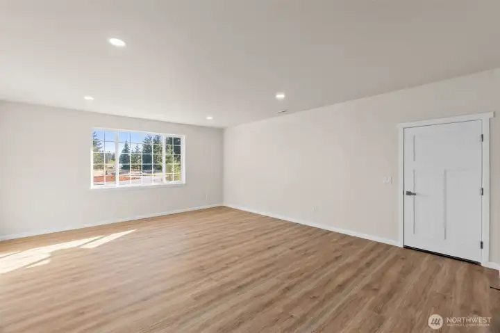 Great room with garage access, and large front facing window.