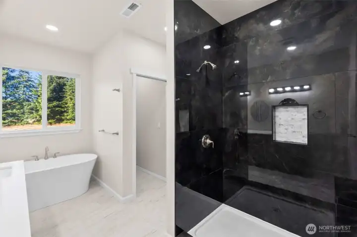 Another view of the primary ensuite, with walk-in-shower and private commode! (also w/ pocket door)