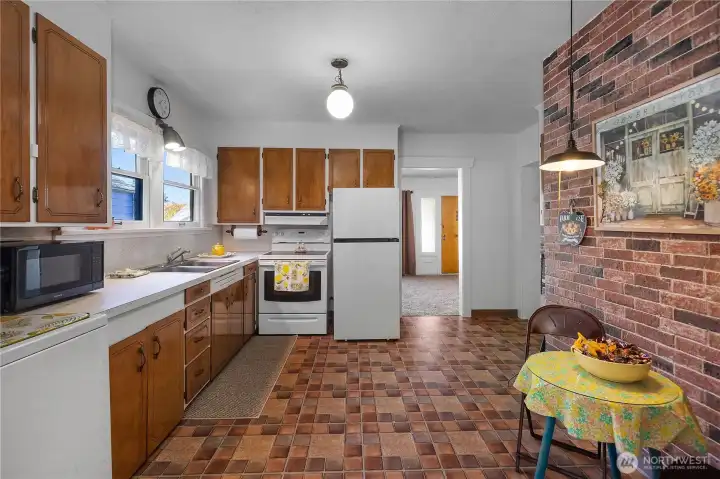 Large kitchen area with new refrigerator.