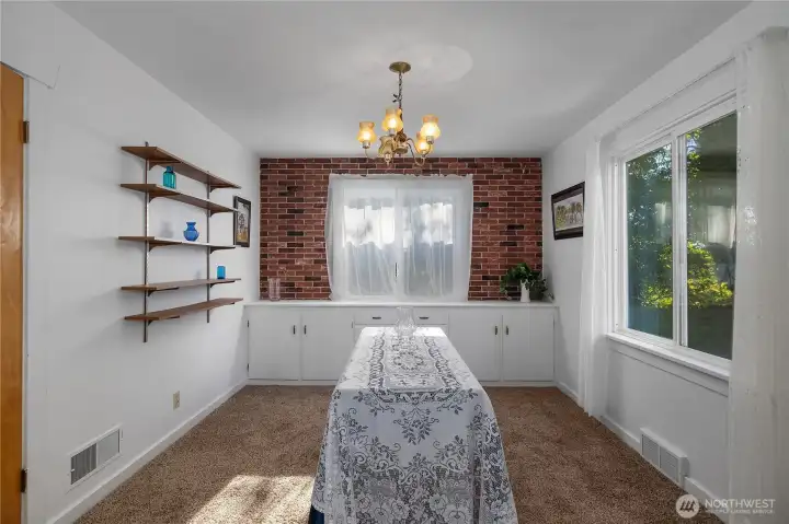 Dining room off of kitchen with beautiful built in cabinetry and large windows making it a light and bright space..