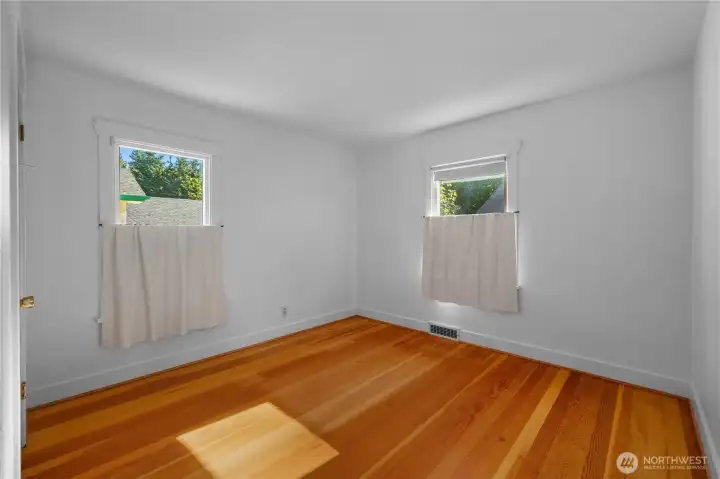Primary bedroom with beautiful hard wood floors.