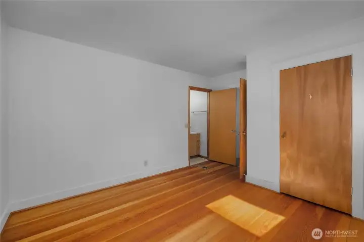 Another view of primary bedroom with half bath.