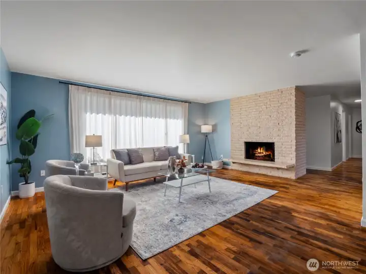 Living room and wood burning fireplace from dining area