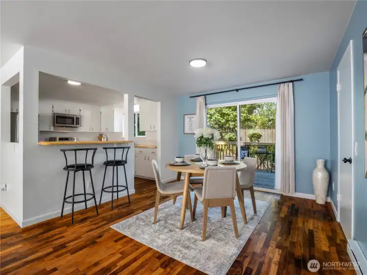 Dining area with access to back deck and attached garage to the right