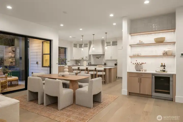 Dining + Wet Bar. An elegant dining area with adjacent wet bar creates a perfect setting for entertaining, seamlessly connected to the great room and kitchen.