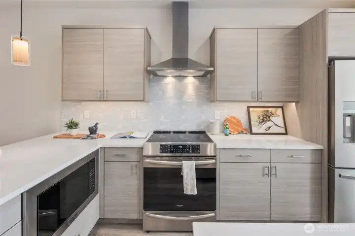 The Courtyard Floor plan kitchens are complete with BOTH an island and peninsula + stainless suite of appliances (fridge included as well as built in microwave) + quartz countertops + natural stone backsplashes + smart induction cooking + full range hood (not those wimpy micro-hoods) + grohe fixtures + undercabinet lighting.  There is even a full pantry closet:).