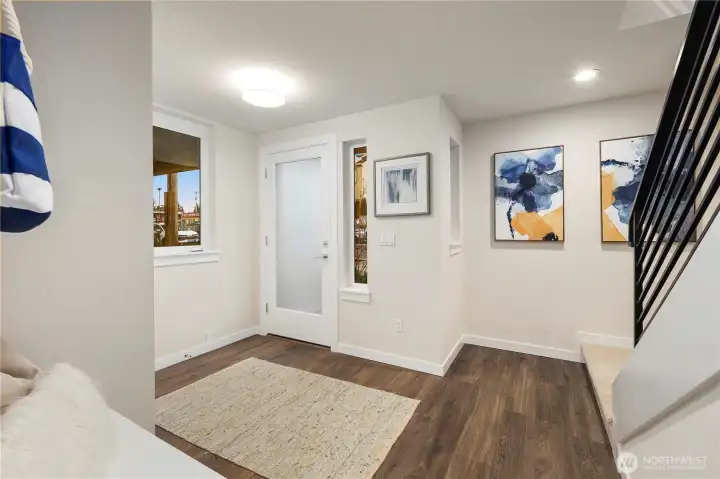 Imagine that....a front foyer!  Features include 2 storage closets, a built in bench with storage, hanging hooks and lots of space to add your personal art and furniture.