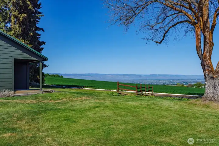 Framed view between the guest home and main residence, drawing your eye out across the valley toward downtown Ellensburg. A stunning vantage point that captures the property’s peaceful setting while keeping you visually connected to town.