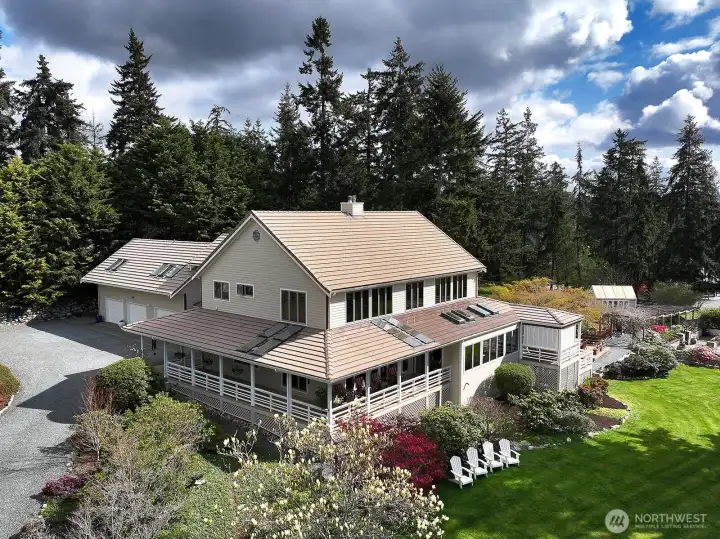 Wrapped deck, 3-car garage with carport.