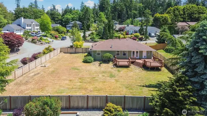 Featuring a fully fenced backyard and expansive deck.