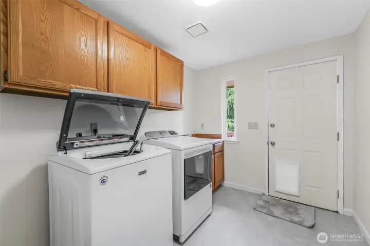 Laundry Room with sink and access to the fully fenced backyard.