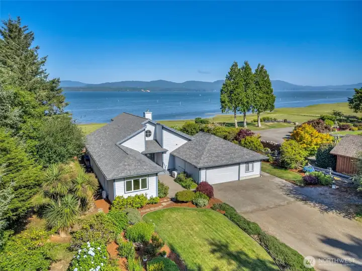Stunning aerial view showcasing the home's exceptional waterfront setting, expansive grounds, and panoramic bay views.