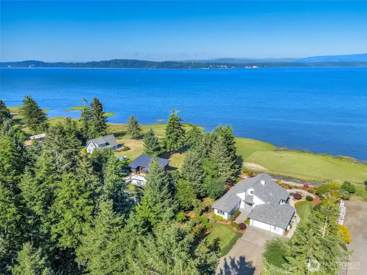 Elevated aerial perspective highlighting the property's private location and breathtaking water frontage.
